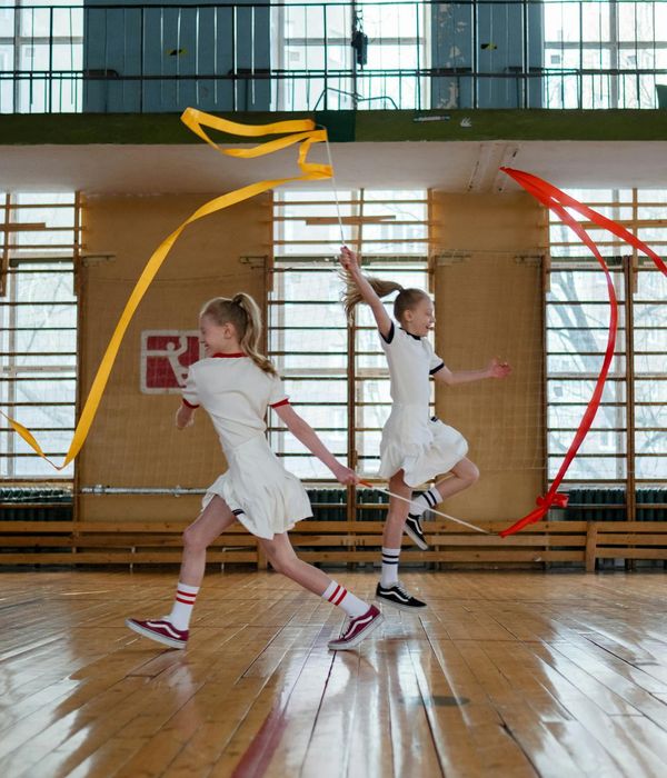 Woman performing rhythmic exercises in a bright minimalist studio space